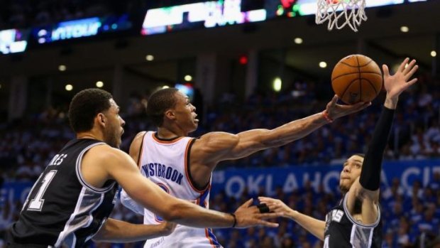 Thunder guard Russell Westbrook drives to the hoop against San Antonio.