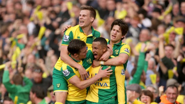 Rejoicing: Norwich City's Martin Olsson, second right, celebrates scoring the winning goal with teammates, during the English Premier League match between Norwich City FC and Newcastle United.