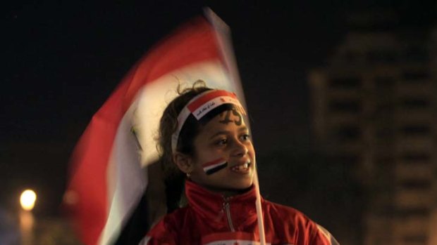 A young demonstrator waves the Egyptian flag in Cairo's Tahrir Square.