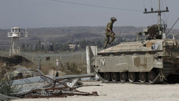 An Israeli soldier manning a tank on the Golan Heights.
