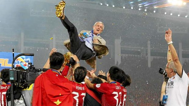Marcello Lippi is hoisted by his players after winning the AFC Champions title.