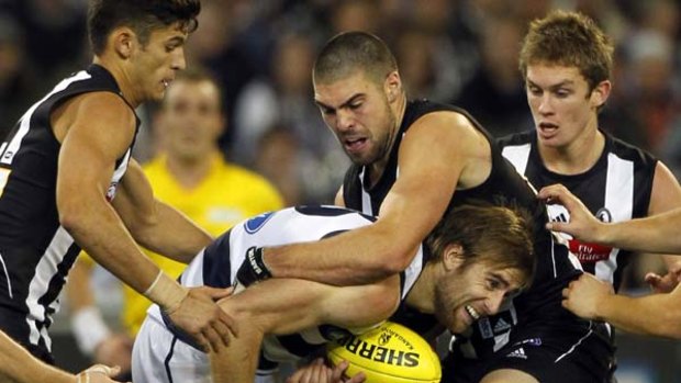 Cats defender Tom Lonergan is tackled by Magpie forward Chris Dawes in round nine.