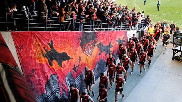 Essendon players return to the rooms after losing to West Coast.