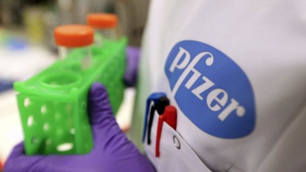 A logo sits on the labcoat of a Pfizer technician unit in Cambridge, United Kingdom. Pfizer has had its $US100 billion takeover bid of British rival AstraZeneca rejected.