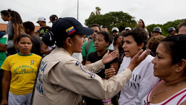 Tensions rise after customers waited in line for hours and their frustration turned into a street protest in Caracas.