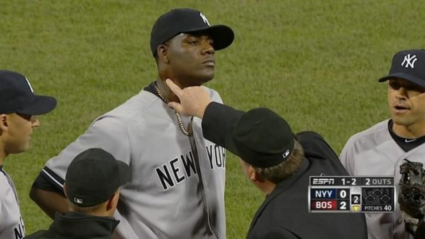 Home plate umpire Gerry Davis examines the Pineda's neck, before the New York Yankees starting pitcher was ejected.