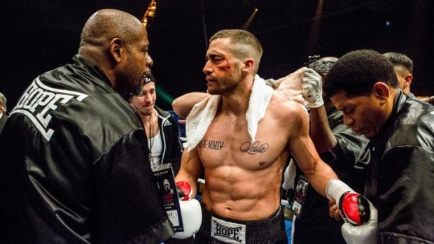 Rippling muscles and a mashed-up face: Jake Gyllenhaal (centre) in <i>Southpaw</i>, with Forest Whitaker (left).