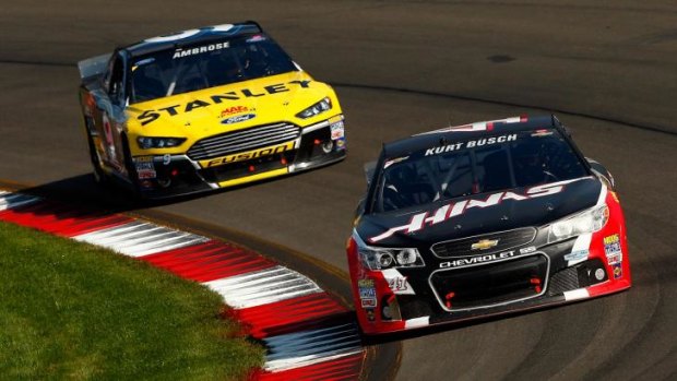 Kurt Busch leads Marcos Ambrose during the race in New York.