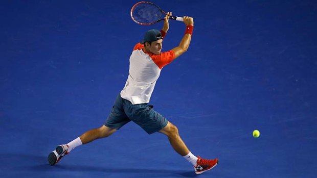 Bernard Tomic plays a backhand before he succumbed to a groin injury.