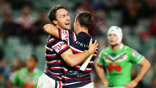 Perspective: James Maloney embraces former halves partner Mitchell Pearce.