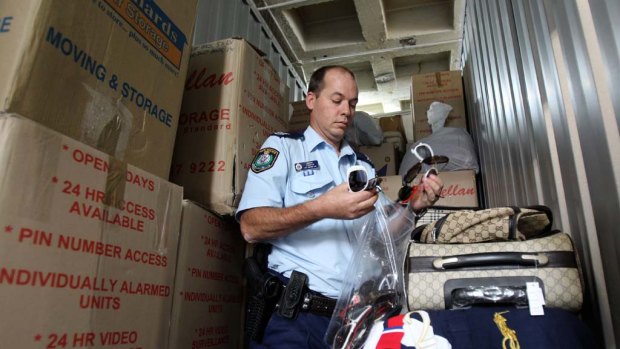 Sergeant Greg Cooper with the counterfeit goods seized in three raids in Sydney.