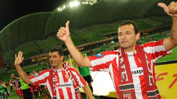 Retiring Heart veterans John Aloisi (left) and Josip Skoko wave goodbye to fans at AAMI Park after last night's 2-2 draw with Sydney FC.