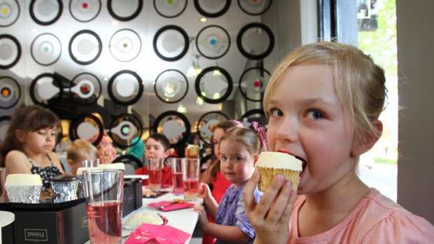Sweet surrender ... six-year-old Isabella Monro tucks in at Sparkle Cupcakery in Surry Hills.