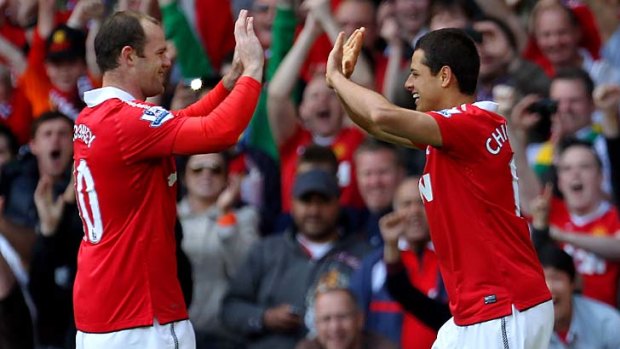 Champions-elect ... Javier Hernandez, right, celebrates with Wayne Rooney after opening the scoring.