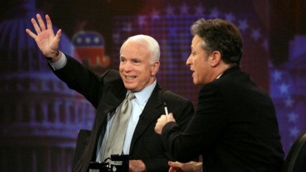 In 2008, Republican presidential candidate John McCain waves to the audience while speaking with Stewart on <i>The Daily Show</i>.