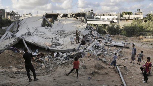 Palestinians look at the rubble of a building destroyed by an Israeli air strike in the northern Gaza Strip town of Beit Lahia on Tuesday.