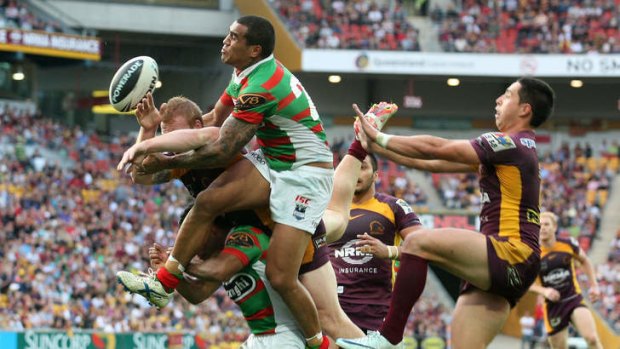 Fetuli Talanoa of the South Sydney Rabbitohs (green and red striped jersey) in action against the Brisbane Broncos.