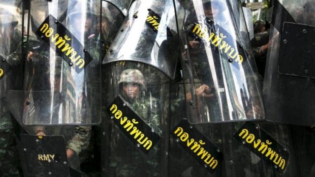 Thai soldiers confront anti-coup protesters in Bangkok.
