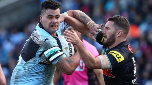 Fend-off: Cronulla's Andrew Fifita palms away Panthers forward Lewis Brown.