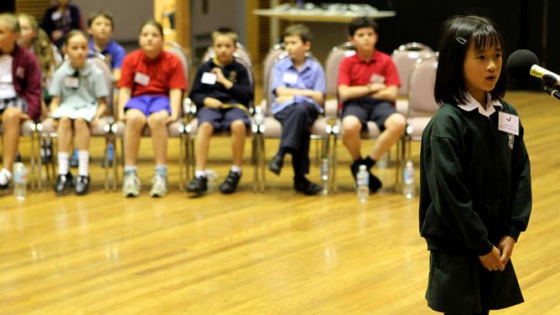 Pressure: Louise Tran steps up to the microphone at the State Junior Final of the Premier's Spelling Bee.