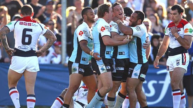 Ben Pomeroy of the Sharks is congratulated by teammates after his try against the Sharks.