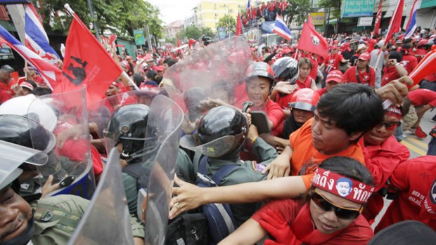 Supporters of former Thai Prime Minister Thaksin Shinawatra clash with riot police outside the venue for a conference for Asian leaders in the holiday resort of Pattaya.