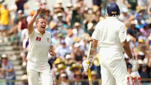 All over: Peter Siddle grabs the wicket of V.V.S. Laxman.