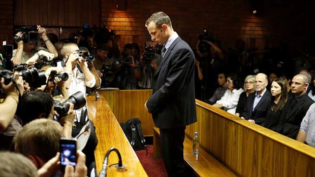 In the dock ... Oscar Pistorius before the start of proceedings at a Pretoria magistrates court.