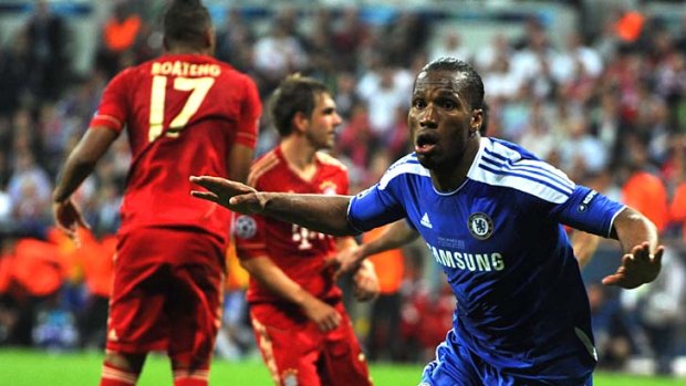 All square ... Didier Drogba celebrates as he equalises for Chelsea with two minutes of normal time to go.