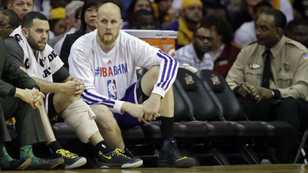 Los Angeles Lakers duo Jordan Farmar and Chris Kaman sit on a nearly empty bench in the fourth quarter against the Cleveland Cavaliers. The Lakers finished with a 119-108 win over Cleveland with only five players able to play, including Robert Sacre who fouled out but was allowed to return by league rule.