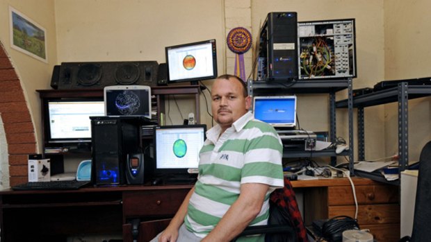 Emu Plains resident John Vandenberg and his bank of powerful PCs and laptops.