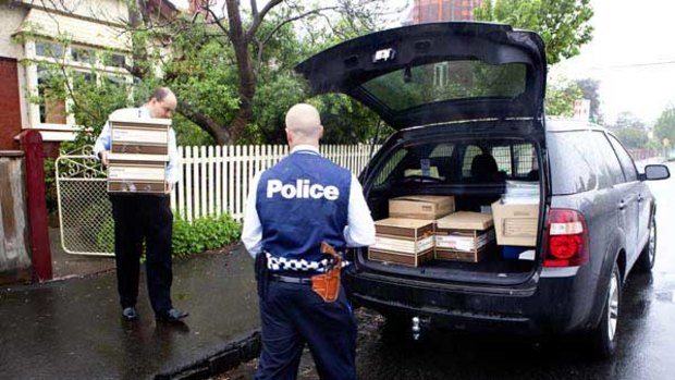 Police remove boxes of evidence from the Hawthorn home of Dr James Peters.