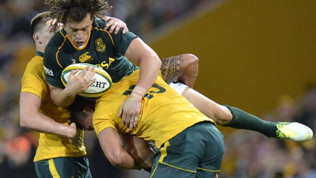 Zane Kirchner is upended by Israel Folau in Brisbane.