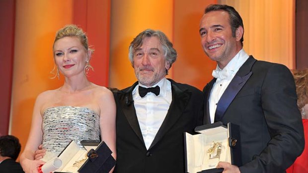 Cannes winners: Jury president Robert De Niro with best actress Kirsten Dunst and best actor Jean Durjardin.