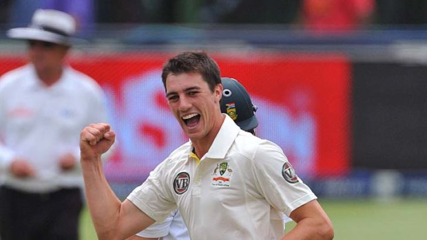 Learning fast: Pat Cummins celebrates taking the wicket of A.B. de Villiers.