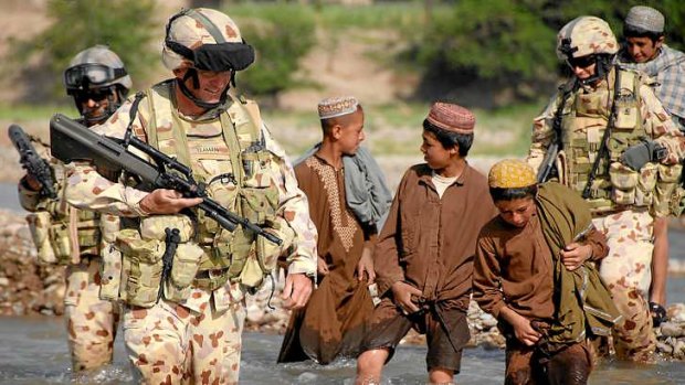 Lieutenant Colonel Stuart Yeaman is followed by enthusiastic Afghan boys.