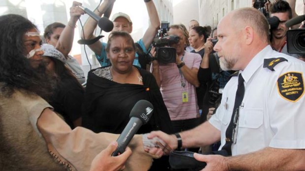Gwenda Stanley, left, accompanied by Barb Shaw, centre, return Prime Minister Julia Gillard's shoe.