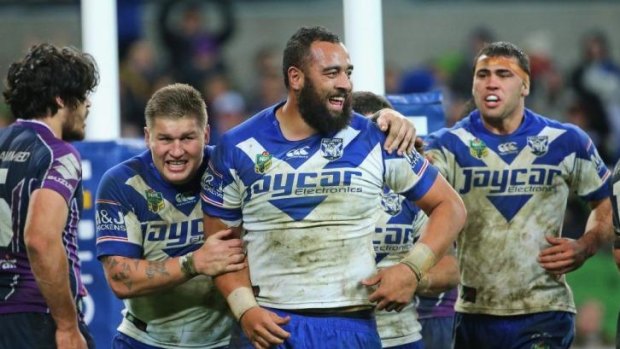 Rare try: Sam Kasiano is congratulated by fellow Bulldogs forward Greg Eastwood after scoring against the Storm.