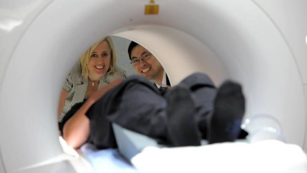 ACT Health Minister Katy Gallagher is given a demonstration of the new MRI equipment by Dr Raymond Kuan, Chairman of the Canberra Imaging Group, with patient Nicholas Jones.