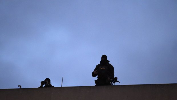 Two snipers of the police stand on the roof of a hotel opposite the French embassy in Berlin, where the German Chancellor along with political and religious leaders were to attend a Muslim community rally to condemn the Paris jihadist attacks.