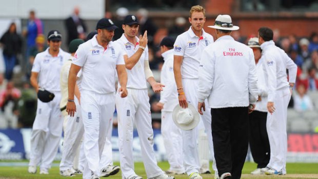 Disbelief: James Anderson and Stuart Broad of England talk to umpire Tony Hill after an unsuccessful appeal for the wicket of David Warner.