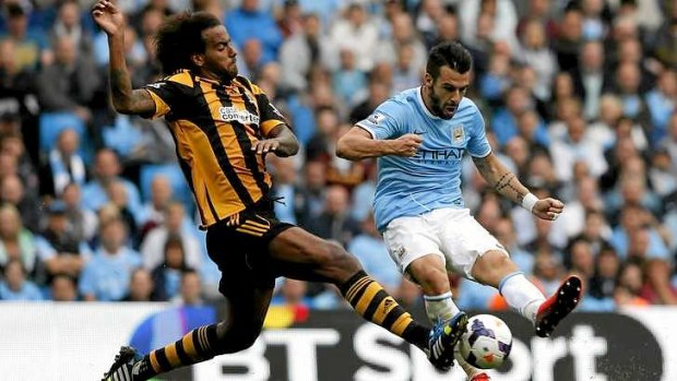 Alvaro Negredo is challenged by Hull City's Tom Huddlestone. The former Seville striker kick-started Manchester City with a second-half goal.