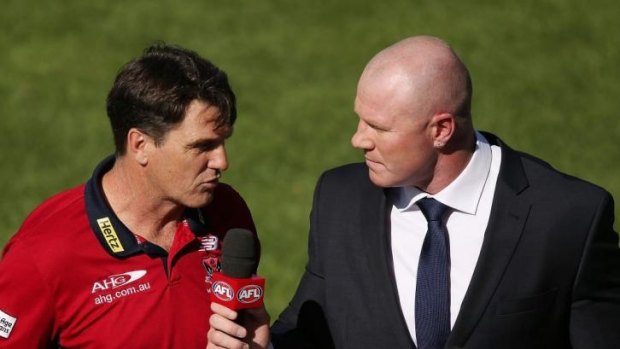 Paul Roos is interviewed by former AFL star Barry Hall during the game.