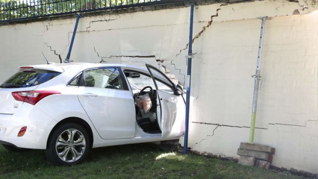 Car lodged in the wall of the Lodge in Canberra after a collision at 8am on Saturday Morning.