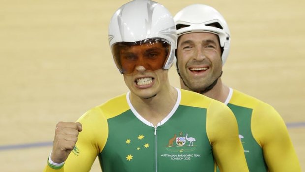 Scott McPhee, left and partner Kieran Modra of Australia celebrate after winning the gold medal in the Men's Individual B Pursuit.