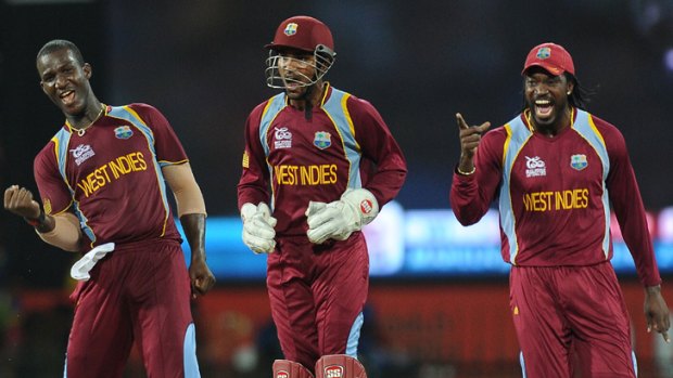 (From left): West Indies captain Darren Sammy rejoices after capturing the wicket of Sri Lanka's captain Mahela Jayawardene, as wicketkeeper Denesh Ramdin and teammate Chris Gayle look on.