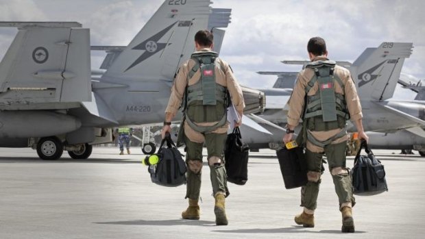 Super Hornet aircrew head to their aircraft in preparation for departure to the Middle East.