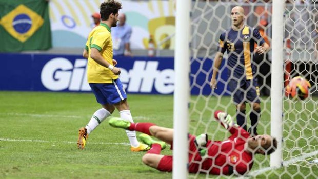 Brazil's Alexandre Pato gets the ball past Australia's goalkeeper, Mark Schwarzer.