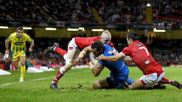 Man of the match: Josh Mantellato of Italy crosses for a try