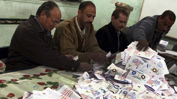 Officials count ballots after polls closed in Bani Sweif, about 115 km south of Cairo on December 22.